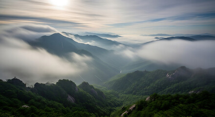 Obraz premium Dramatic sunrise over majestic mountain peaks shrouded in ethereal mist, creating a breathtaking and serene natural landscape view that inspires awe and tranquility