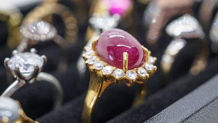 Gold jewelry red ruby diamond rings show in luxury retail store display showcase