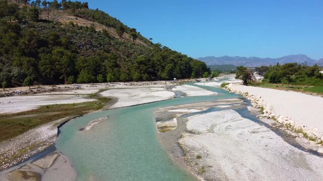 Aerial footage showcasing the stunning natural beauty of Saklikent National Park in Fethiye, Turkey. The video captures the vibrant turquoise waters of the Xanthos River flowing through the dramatic c