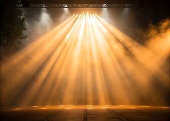 Dramatic stage lighting illuminates empty performance space with golden haze