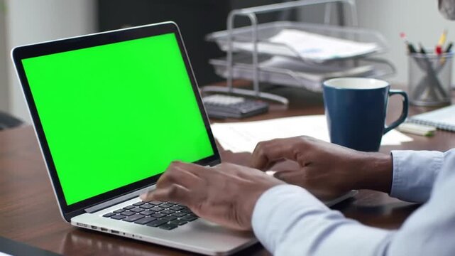 Businessman Hands Typing on a Laptop with Green Screen.