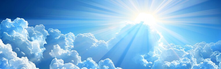 Golden sunlight beams streaming through fluffy white clouds in blue sky