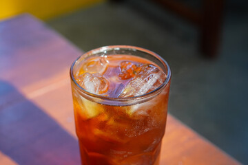 Iced Tea, captured on October 2, 2025. Refreshing chilled black tea served in a clear glass with ice cubes and lemon slice, golden amber color, perfect summer beverage lifestyle photography