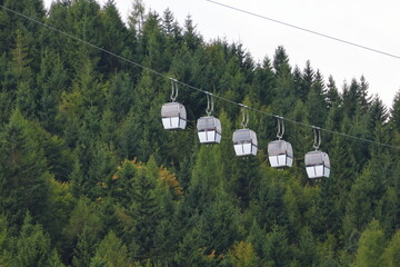 Gondola cable car goes up the mountain, alpine transport, scenic tourism, aerial travel adventure