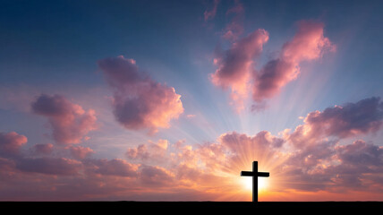Beautiful cross silhouette stands against vibrant sunset, with sun rays illuminating clouds in stunning display of colors. This scene evokes sense of peace and spirituality