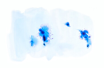 Abstract blue ink splatter on white background with flowing watercolor effects.