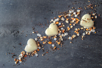 heart-shaped cookies and spices festive arrangement on a black slate background