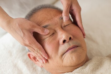 Elderly Man Receiving Relaxing Facial Massage