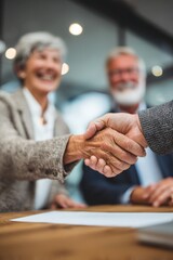 Senior couple shaking hands with professional insurance agent broker in modern office for consultation meeting discussing financial security protection policy planning and retirement coverage.