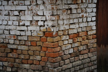 The brick wall of the old garage and barn.