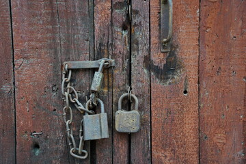 The lock on the old wooden door of the garage and barn.