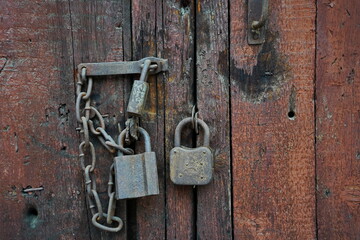 The lock on the old wooden door of the garage and barn.