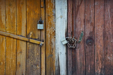 The lock on the old wooden door of the garage and barn.