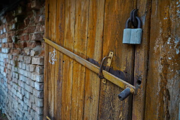 The lock on the old wooden door of the garage and barn.