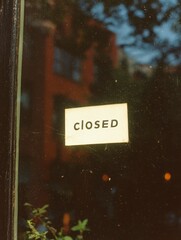A closed sign is on a window