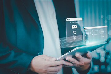 Business professional holding tablet with holographic AI interface showing contact us icons, symbolizing secure customer communication, digital assistance, and next-gen data access modern technology.