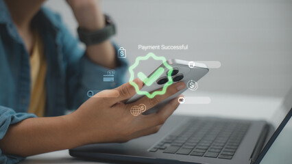 Close-up of hand holding smartphone showing Payment Successful message, representing secure mobile...