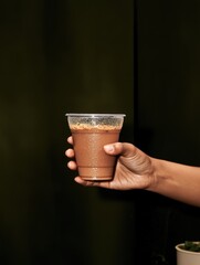 A person is holding a cup of coffee