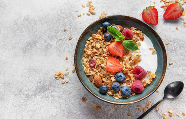 Granola bowl with yogurt, berries, and nuts for breakfast
