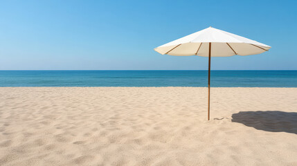 Beach umbrella casting shadow on empty sand, creating serene atmosphere by ocean