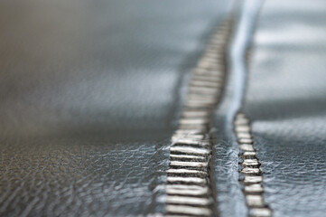 background, close up, selective focus of torn black sofa upholstery