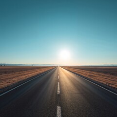 Naklejka premium Road to Horizon: An endless road stretches towards the horizon, framed by fields under a vast blue sky, inviting exploration and adventure.