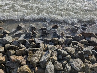 Rocks by the seaside with waves at the top