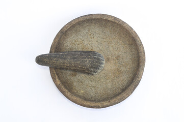 Lumpang atau cobek made of natural stone is a traditional tool for pounding and mixing spices. Isolated on a white background.