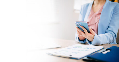 Fototapeta premium Businesswoman hands typing on smartphone and laptop keyboard in morning light computer, typing, online in office