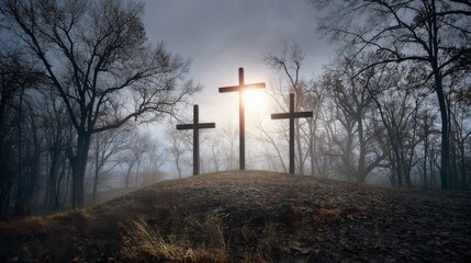 Obraz premium Three large crosses stand on a misty hill during sunrise or sunset,