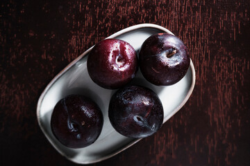 organic fresh ripe plum, seasonal fruit in rustic style