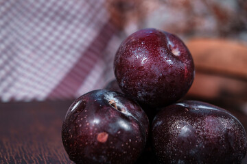 organic fresh ripe plum, seasonal fruit in rustic style