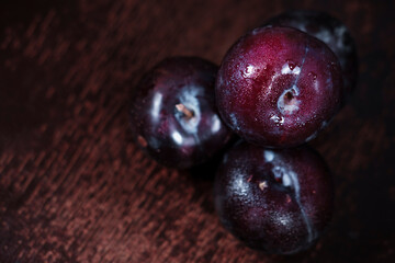 organic fresh ripe plum, seasonal fruit in rustic style