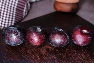 organic fresh ripe plum, seasonal fruit in rustic style