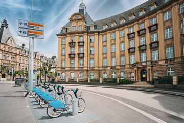 Fototapeta premium LUXEMBOURG. Row of city bikes for rent on a background of bank building