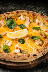 Closeup seafood pizza with shrimp, salmon, and basil