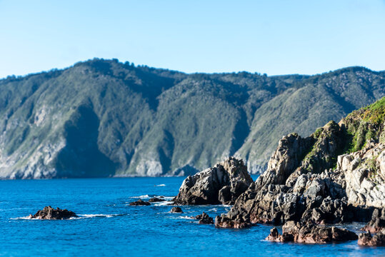 Rocky cliffs rise along the Chilean coast near Caleta Quintay, Chile.