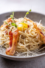 Closeup spaghetti carbonara with bacon and egg yolk