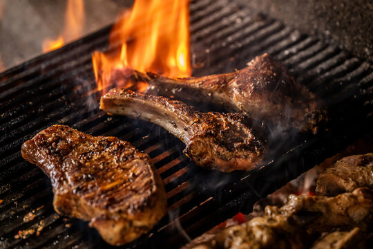 Grilled lamb chops and pork steak over open flame