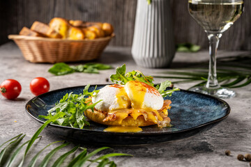 Eggs Benedict with hollandaise and arugula