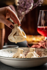 Traditional Georgian khinkali dumpling in hand