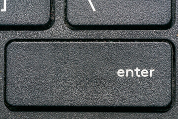 The enter button on a black keyboard. Close up.