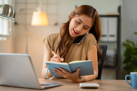 women talk mobile phones appointment reminders in calendar on interface. working on laptop computers, online business. - Powered by Adobe