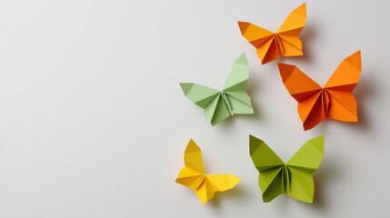Colorful origami butterflies in various shades, arranged artistically on a light background, showcasing creativity and craftsmanship.