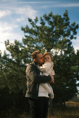 A Father Embracing His Child in a Beautiful and Serene Nature Setting Surrounded by Fresh Air