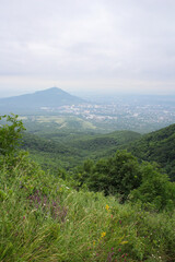 Mountain landscape with a view of the city and green hills