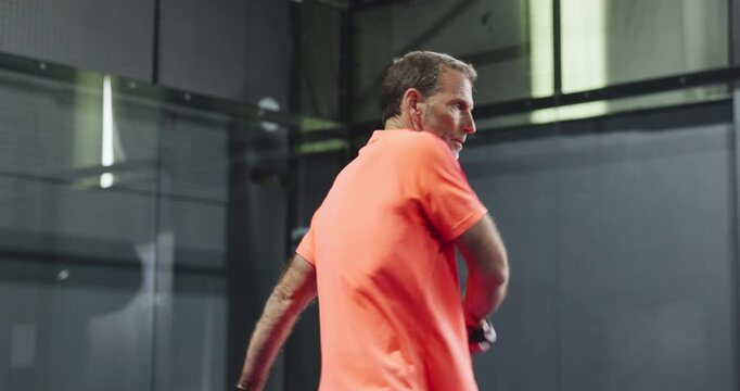 Padel, tennis and mature man on court for training, match and practice game in sports club. Fitness, exercise and person with racket, ball and serve for challenge, tournament and playing competition