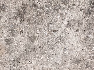 Rough textured concrete wall surface background with small pebbles and speckles