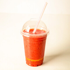 Refreshing strawberry smoothie in clear plastic cup with straw, perfect for healthy lifestyle blogs and vibrant summer promotions to attract health-conscious buyers