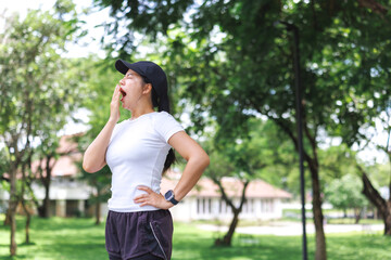 Woman yawning feeling tired after exercise